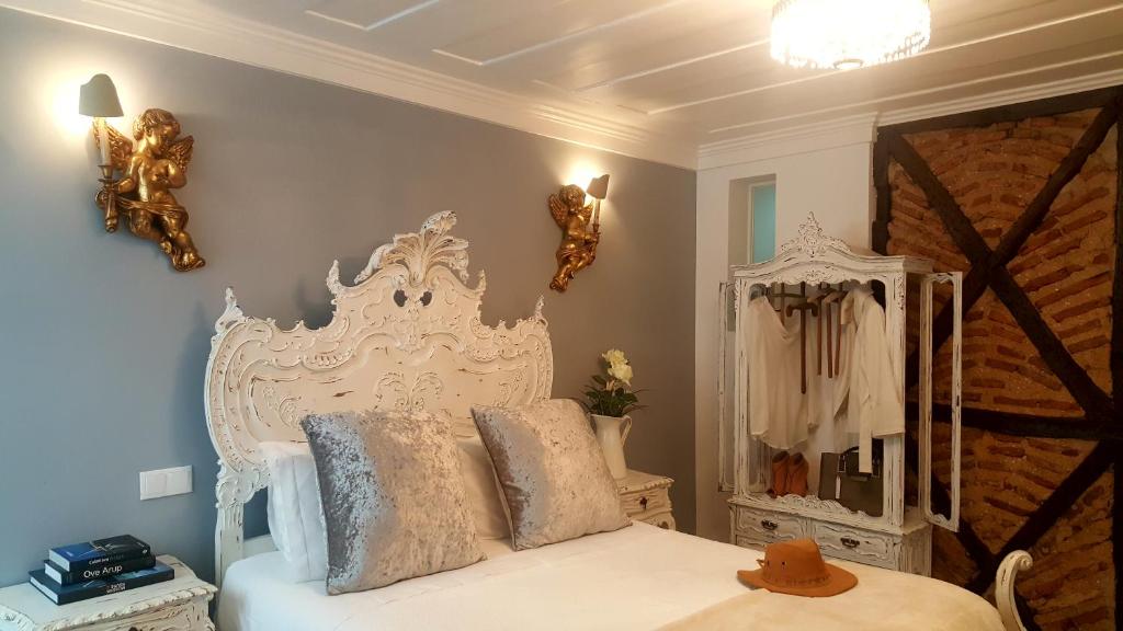 a bedroom with a white bed and a mirror at Charming Apartment I Historical Center in Lisbon