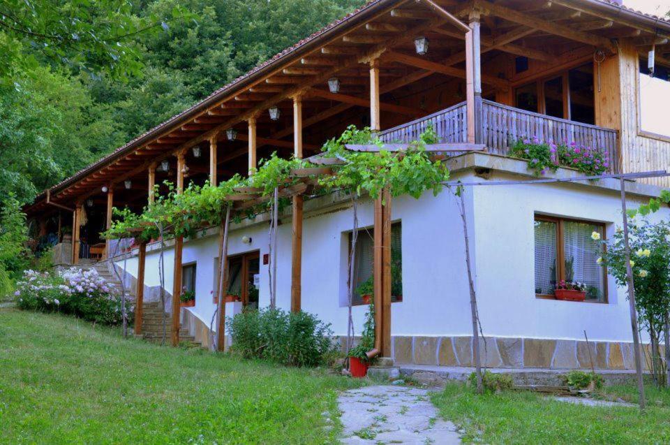 a house with a balcony on the side of it at Sinia Vir Eco Residence in Medven