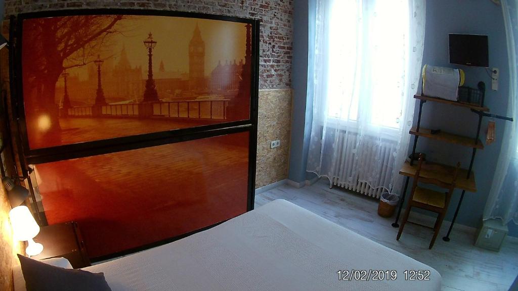Postel nebo postele na pokoji v ubytování Hostal Hispalense