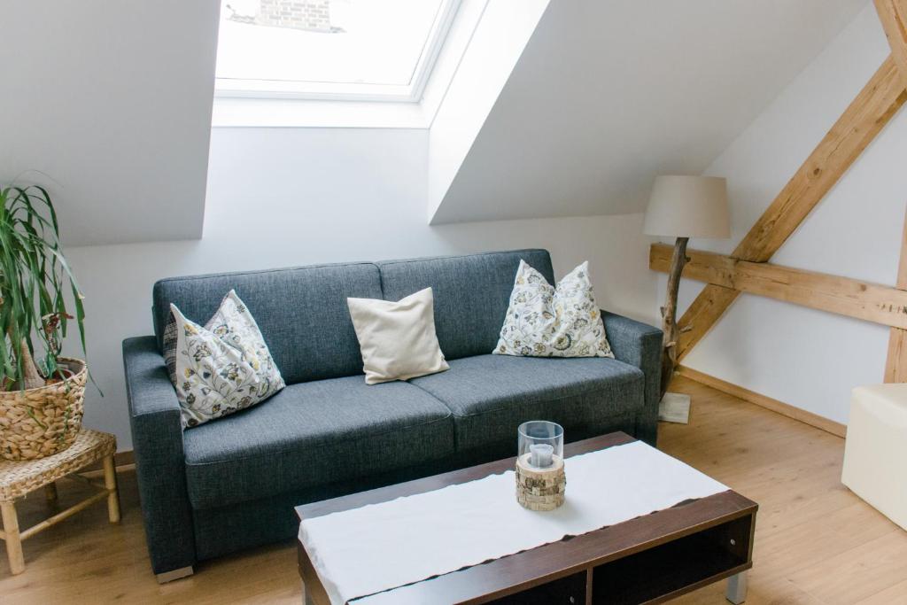 a living room with a blue couch and a table at Haus Auszeit in Rauris