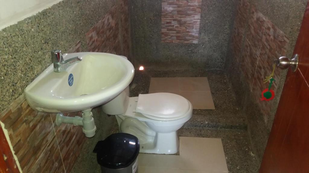 a bathroom with a sink and a toilet at PLAYA ARCO IRIS in Cabo de la Vela