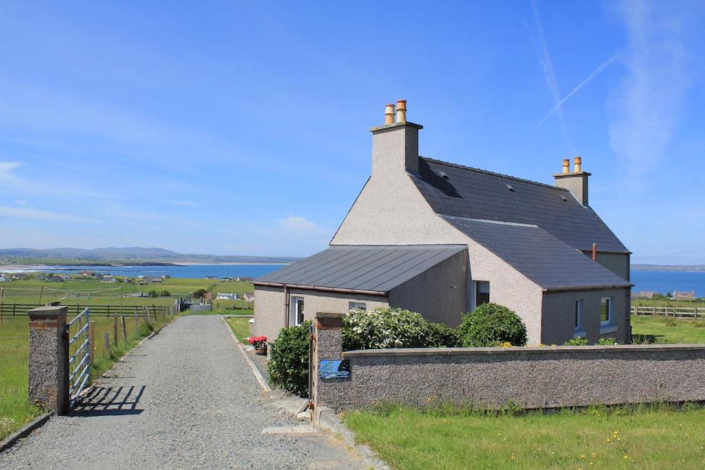 a house on the side of a road at Seascape Cottage in Knock