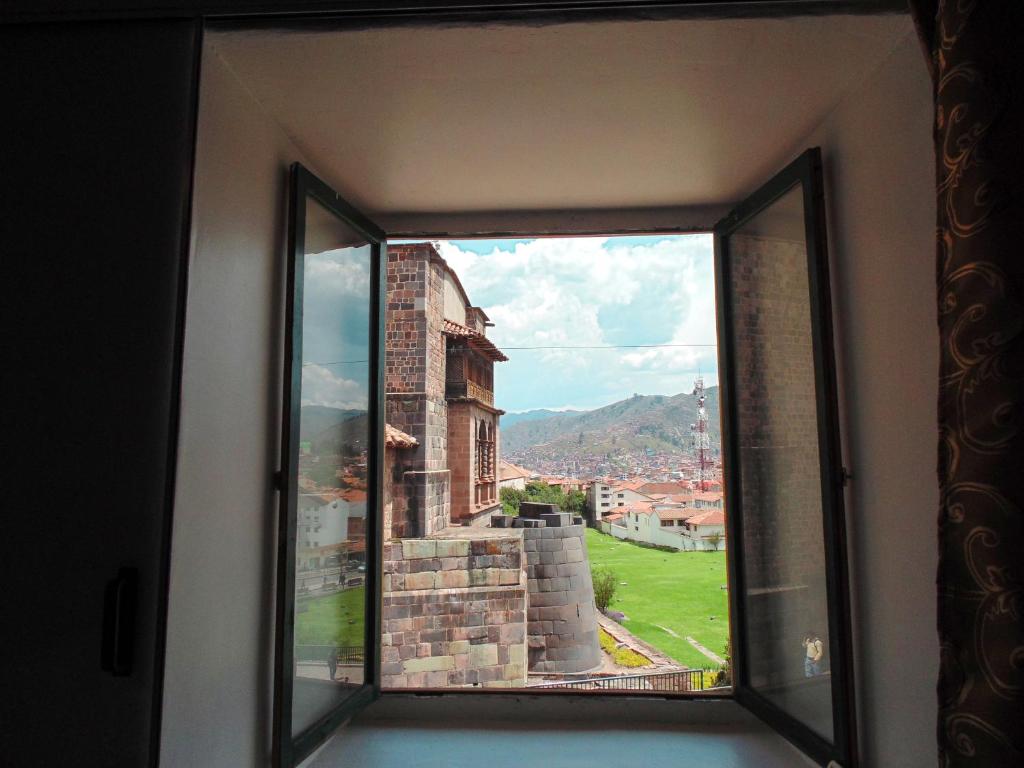 a window with a view of a city at Sight Qoricancha in Cusco
