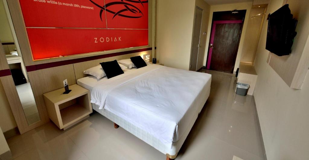 Postel nebo postele na pokoji v ubytování Zodiak Kebon Kawung by KAGUM Hotels