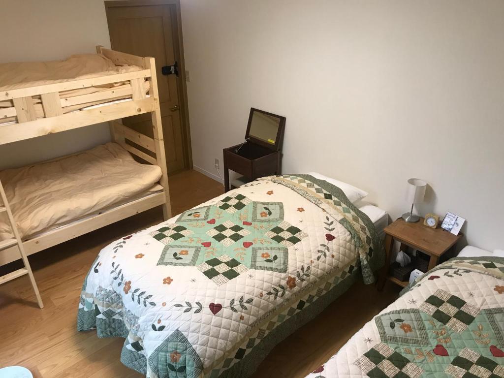 Postel nebo postele na pokoji v ubytování Guest House Chaconne Karuizawa