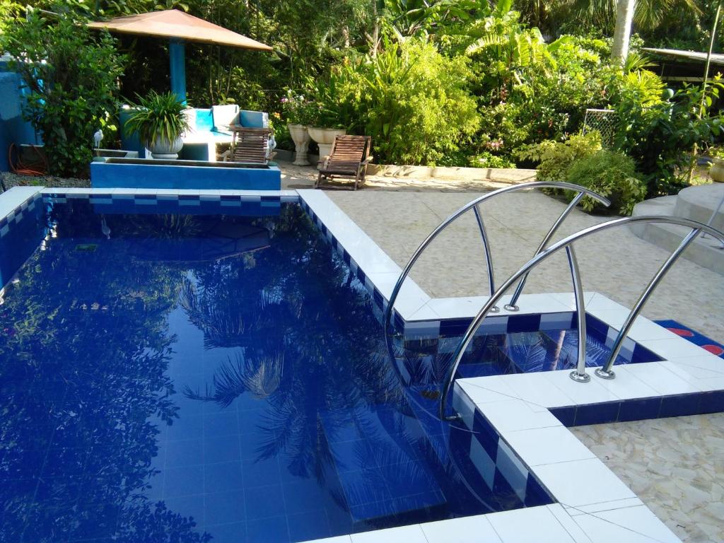 a swimming pool with a blue and white tile floor at Abha Villa in Galle