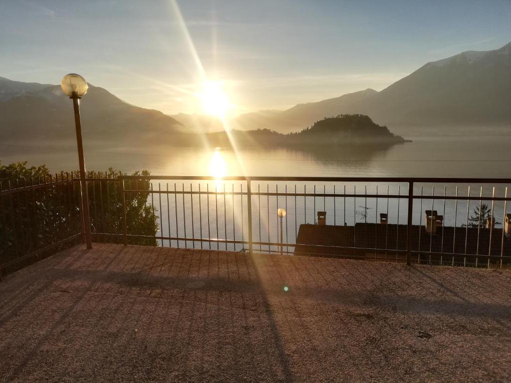 a sunset over a body of water with mountains in the background at Casa Sofie e Charlotte in Varenna