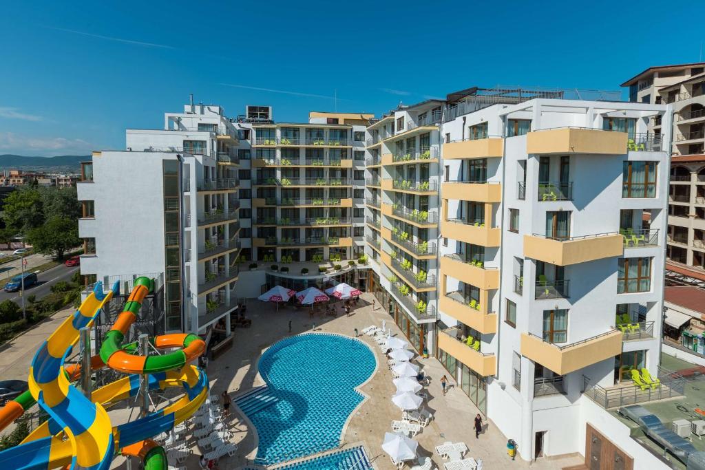 an apartment building with a pool and a water slide at Best Western PLUS Premium Inn in Sunny Beach