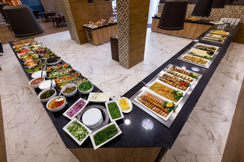 a buffet of different types of food on a table at Best Western PLUS Premium Inn in Sunny Beach