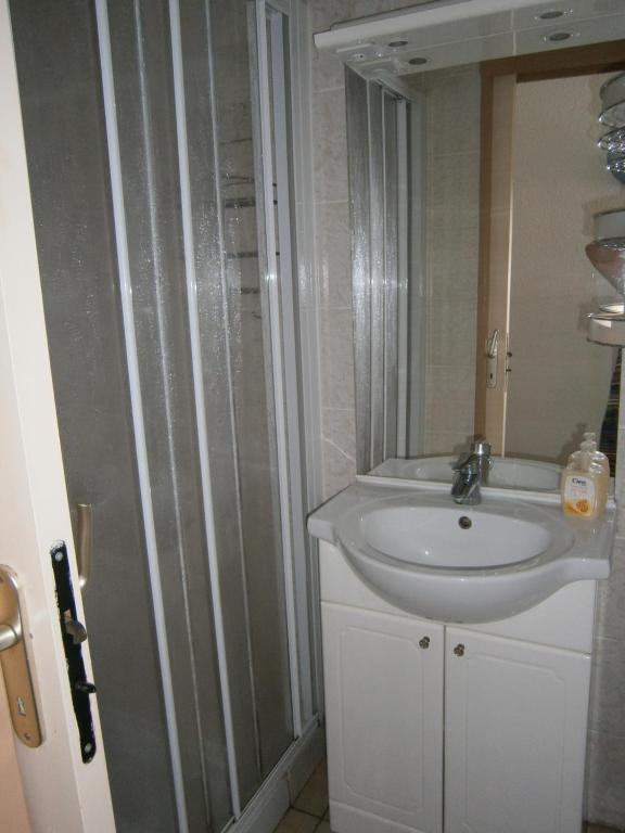 a bathroom with a white sink and a mirror at LES OCEANIDES in Brétignolles-sur-Mer