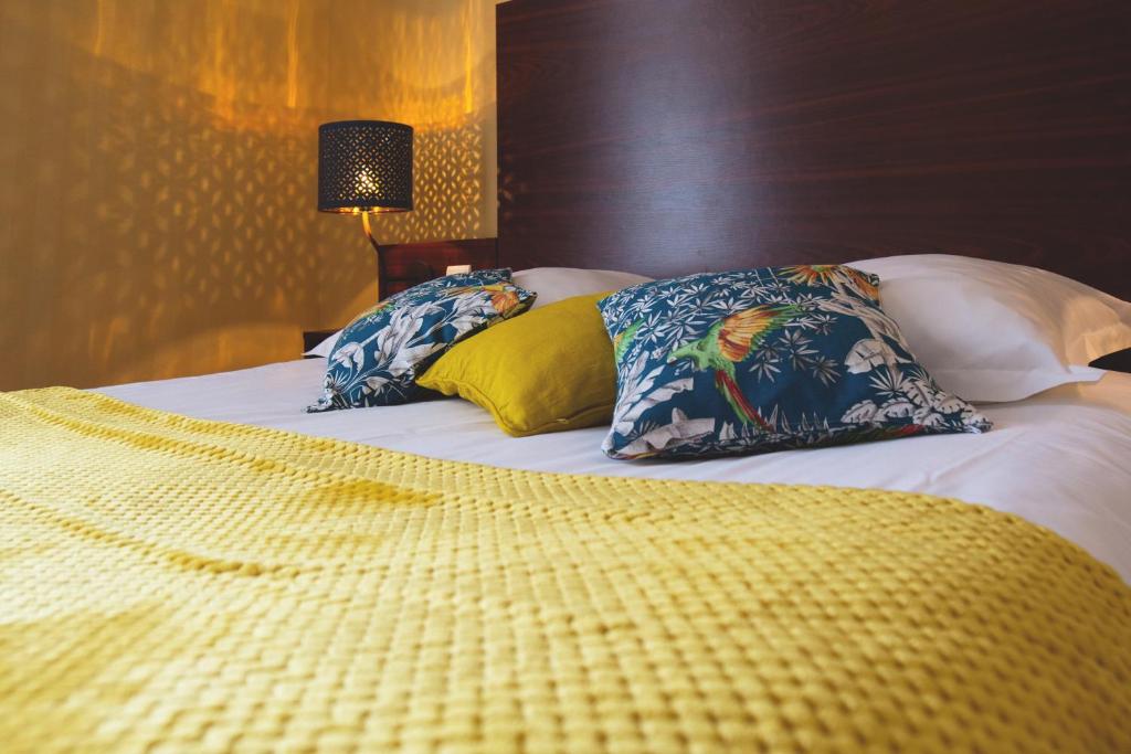 Postel nebo postele na pokoji v ubytování Hôtel Les Coutainvillaises