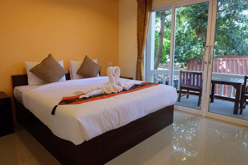 a bedroom with a bed with a towel on it at family guesthouse chaweng in Chaweng