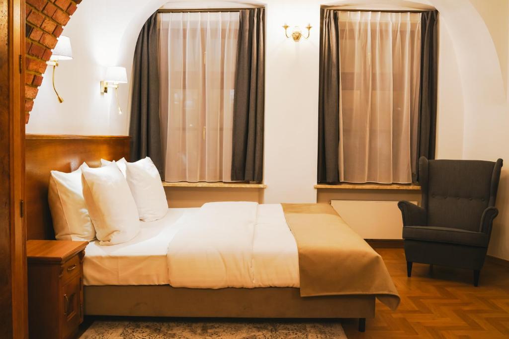 Postel nebo postele na pokoji v ubytování Hotel & Apartments Ventus Rosa