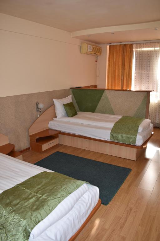 Postel nebo postele na pokoji v ubytování Hotel Zimbru