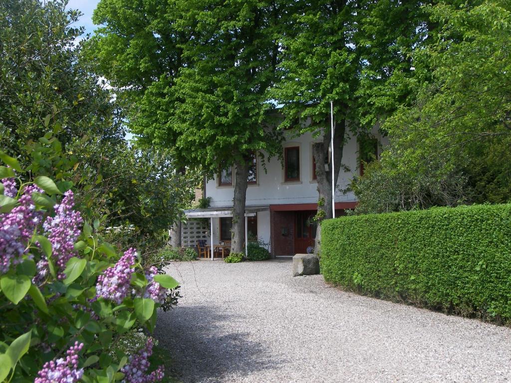 a house with trees and flowers in front of it at Ferienhof Lange in Fehmarn