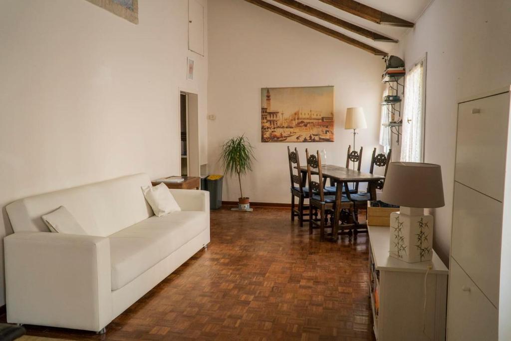 a living room with a white couch and a table at Attic in San Marco in Venice