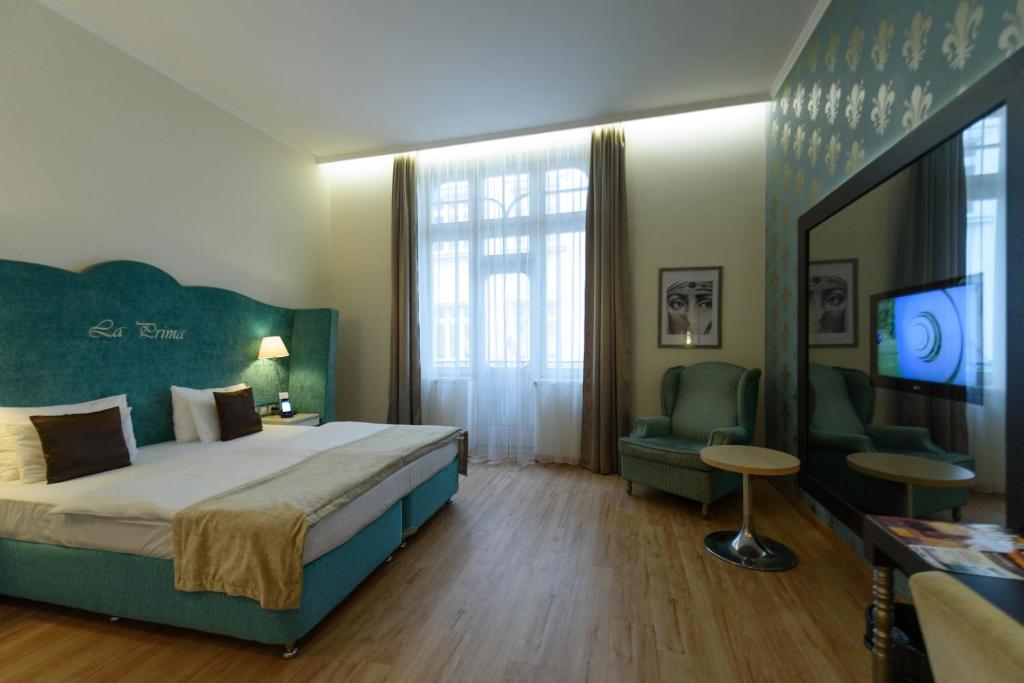 A bed or beds in a room at La Prima Fashion Hotel Budapest