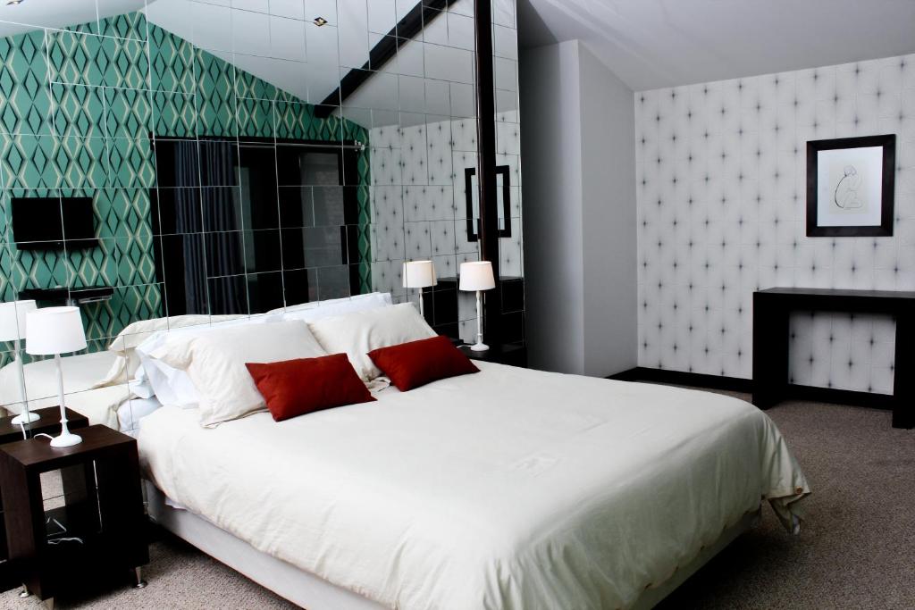 Postel nebo postele na pokoji v ubytování Hotel Casa Gardenia