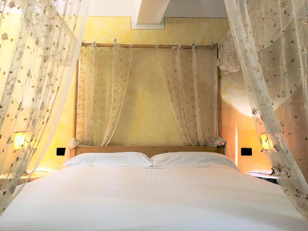 Posteľ alebo postele v izbe v ubytovaní SIENA ROMANTIC EXPERIENCE
