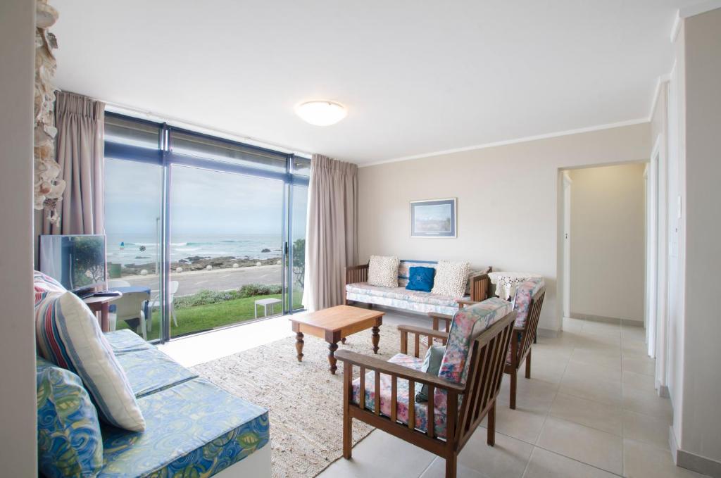 a living room with a view of the ocean at Herolds Bay Accommodation - Smalstaan Downstairs in Herolds Bay