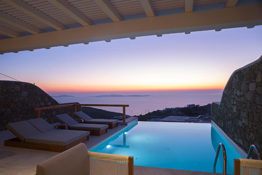 a villa with a pool and a view of the ocean at VILLA APOLLO-PRIVATE POOL-AMAZING VIEW in Mýkonos City