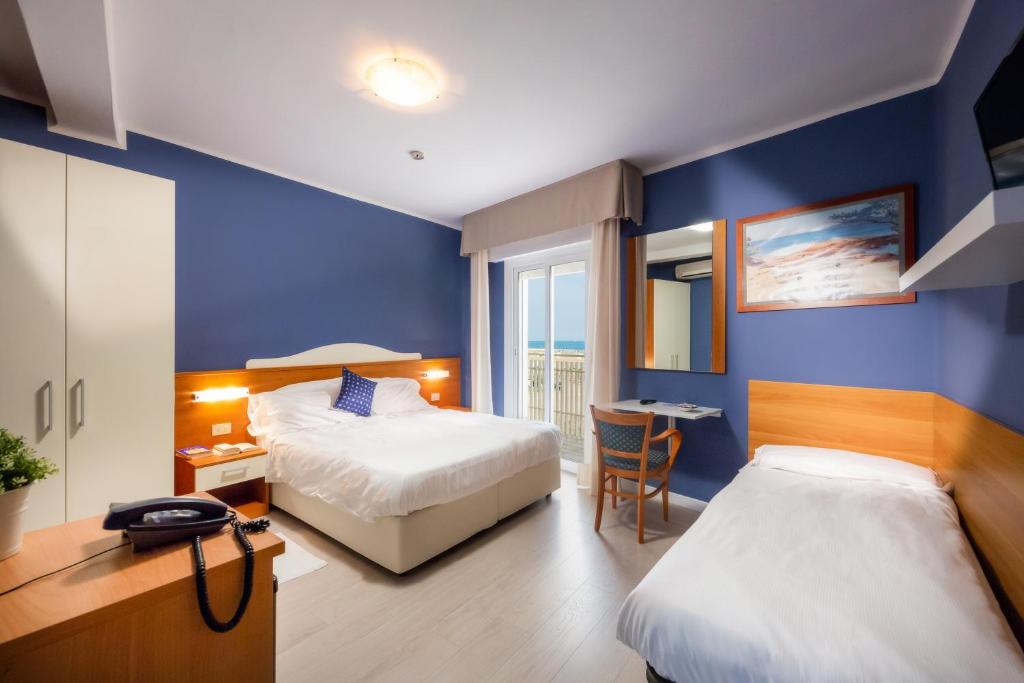 Postel nebo postele na pokoji v ubytování Hotel Verona