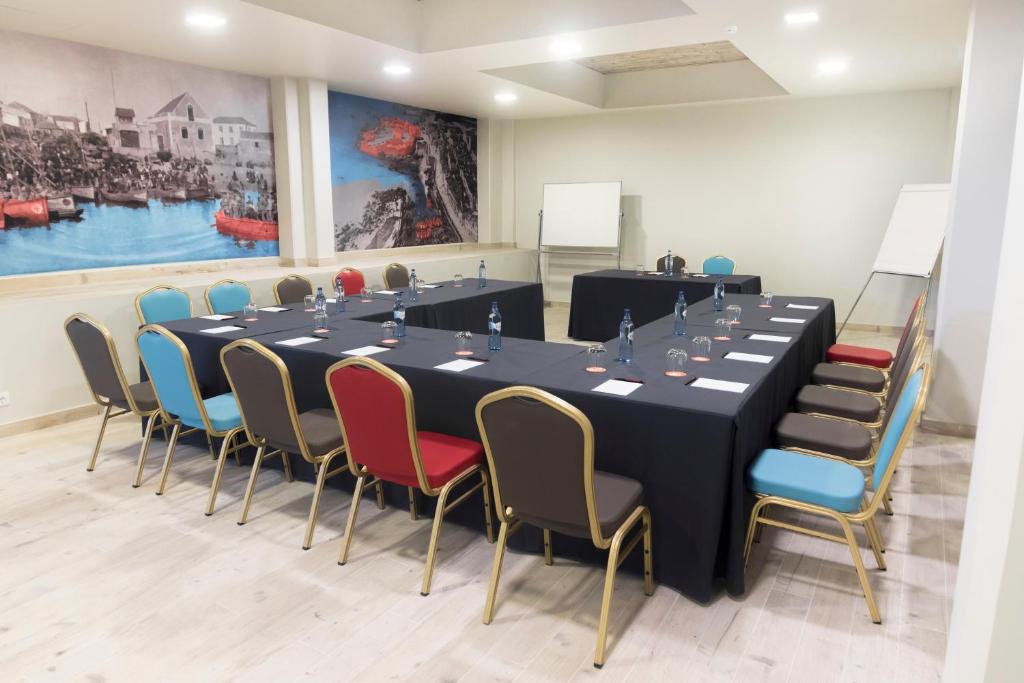 a conference room with a long table and chairs at Star inn Peniche in Peniche