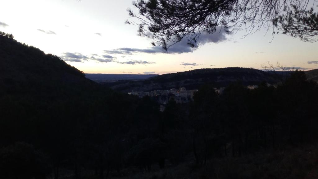 a view of a valley with a town in the distance at Casa Rural Mirabueno in Cuenca