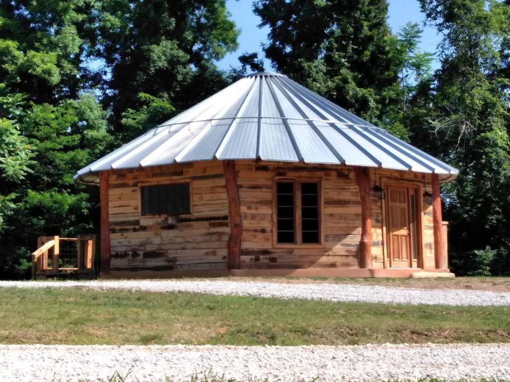 uma cabana de madeira com um telhado de estanho em The Mountaineer - Rustic Mountain Yurt em Genoa