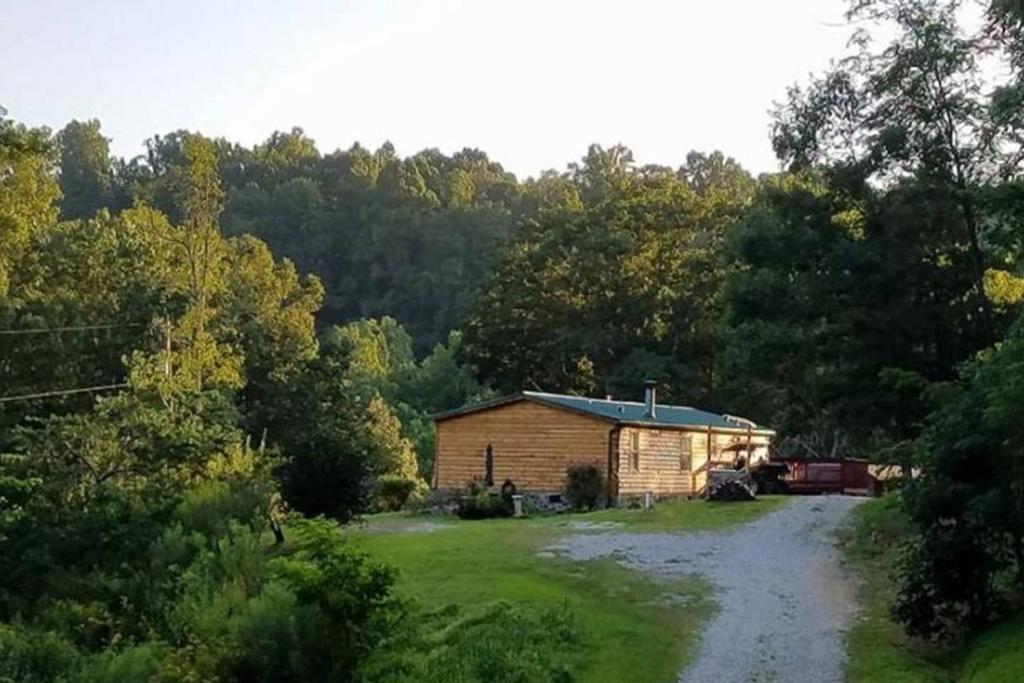 a small building in the middle of a field at The Sandstone - A 3BR, 2BA Deluxe Log Cabin in Genoa