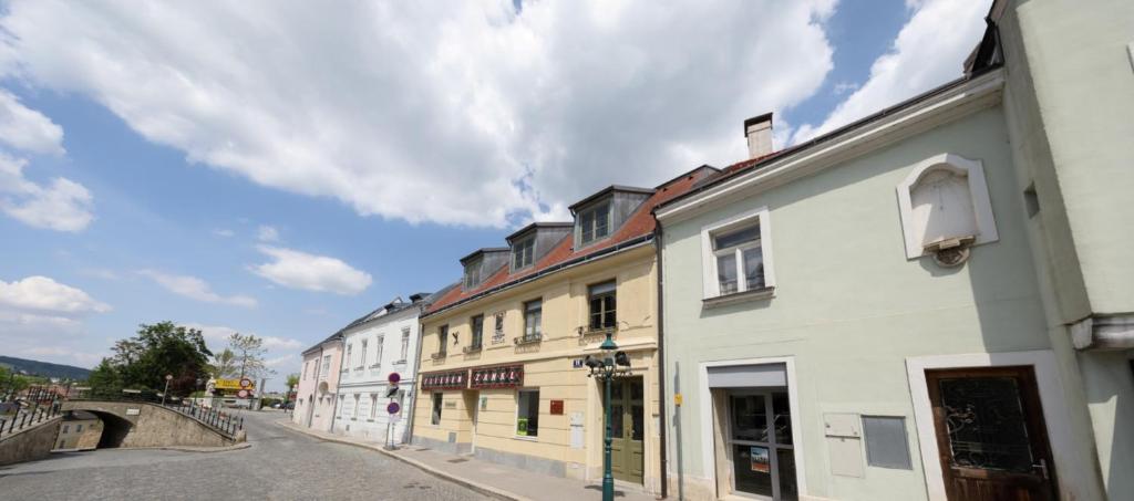 a row of buildings on a street next to a bridge at Stifts-Suite in Klosterneuburg