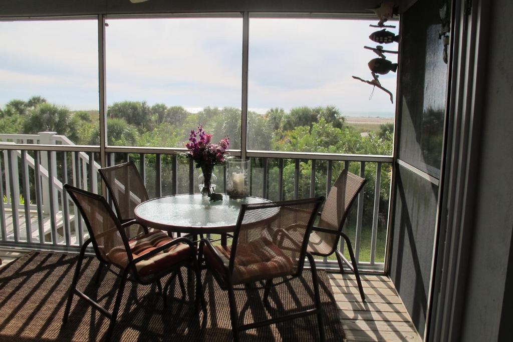 a table and chairs on a balcony with a view at Palm Island Villa 3 Bedroom Superior Villa in Cape Haze
