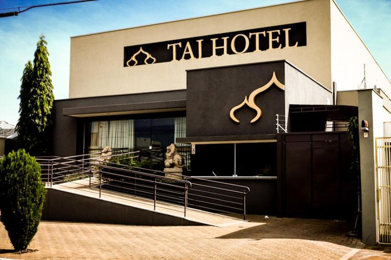 a hotel with a sign on the front of it at Taj Hotel in Três Lagoas