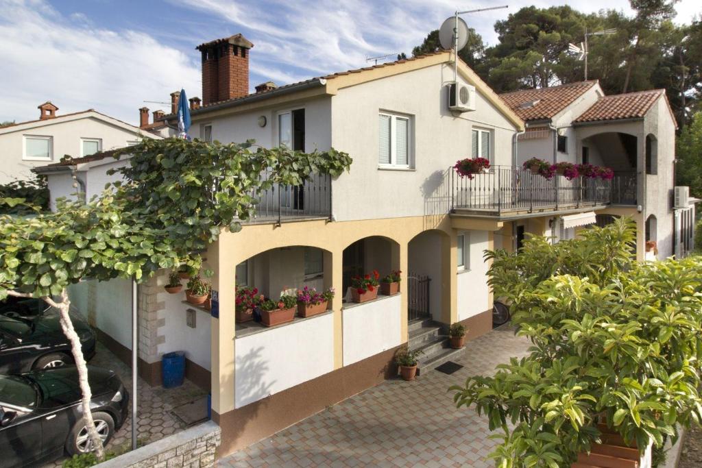 a house with balconies and potted plants on it at Apartment in Porec with One-Bedroom 7 in Poreč