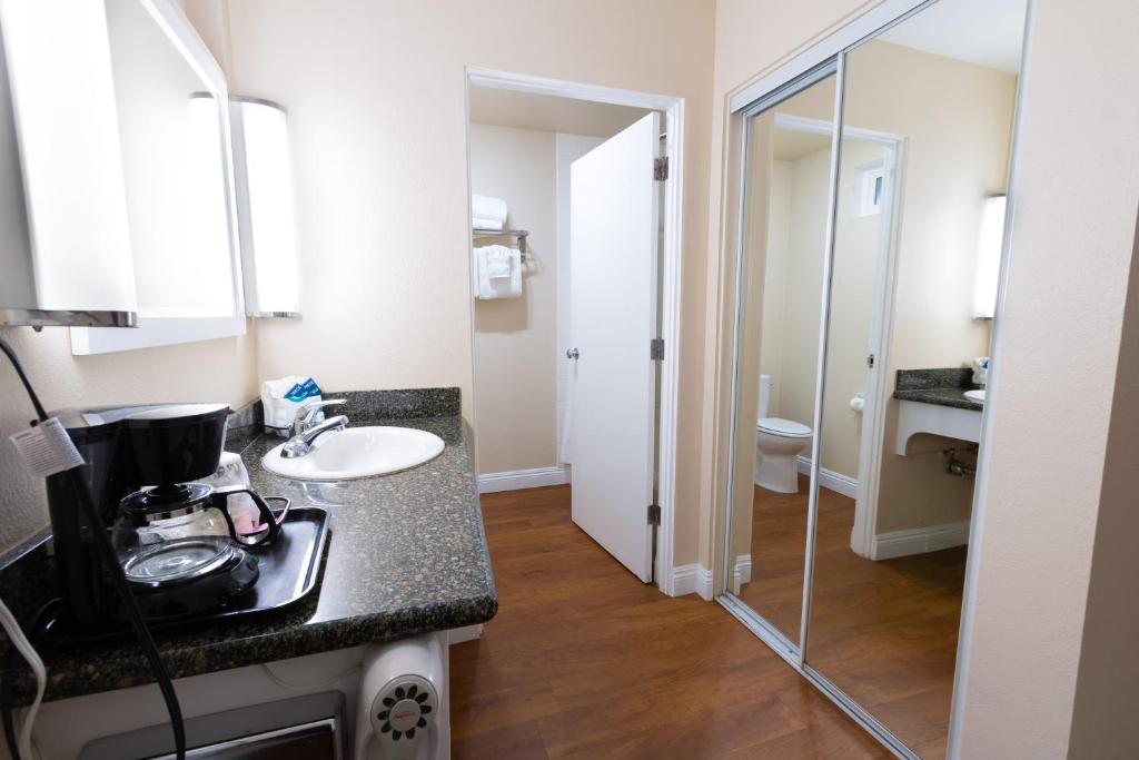 a bathroom with a sink and a glass shower at Pea Soup Andersen's Inn in Buellton