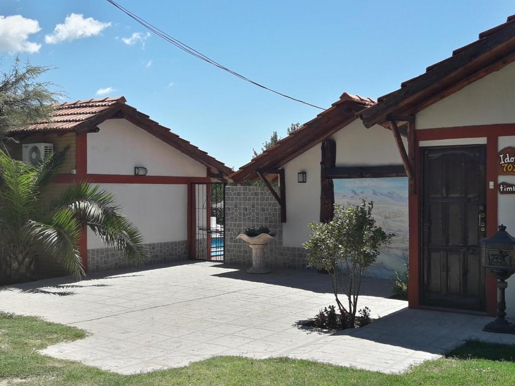 a house with a patio in front of it at Hosteria Santa Francisca in Villa Cura Brochero