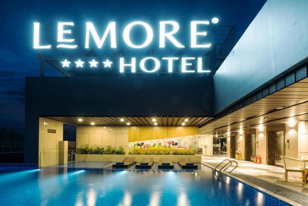 a hotel swimming pool with a sign that reads more hotel at LeMore Hotel Nha Trang in Nha Trang