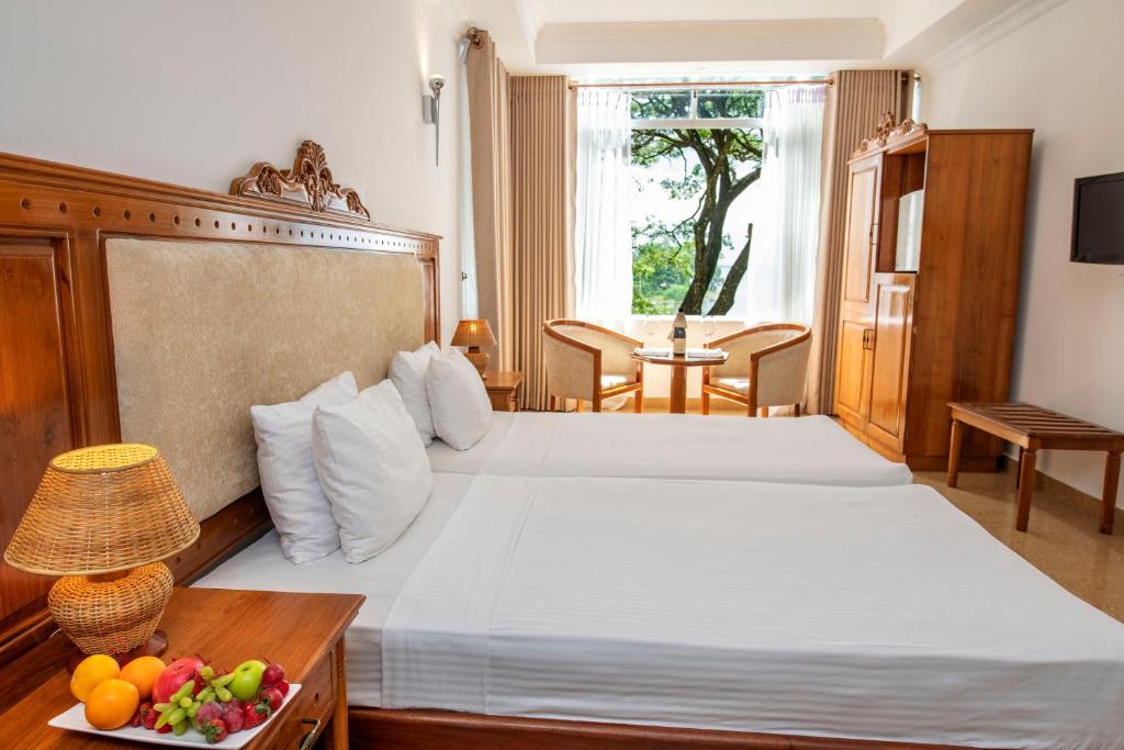 Postel nebo postele na pokoji v ubytování Hotel Sudu Araliya