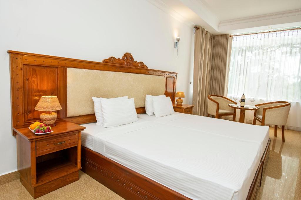 Postel nebo postele na pokoji v ubytování Hotel Sudu Araliya