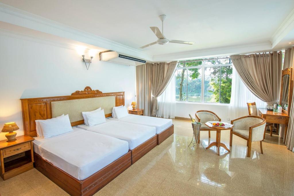 Postel nebo postele na pokoji v ubytování Hotel Sudu Araliya