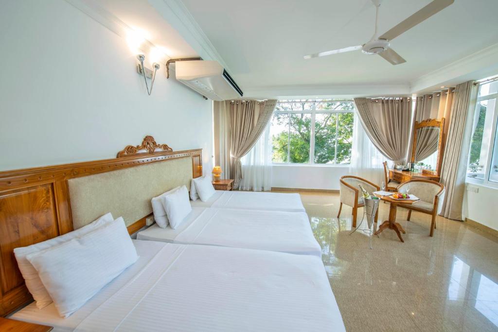 Postel nebo postele na pokoji v ubytování Hotel Sudu Araliya