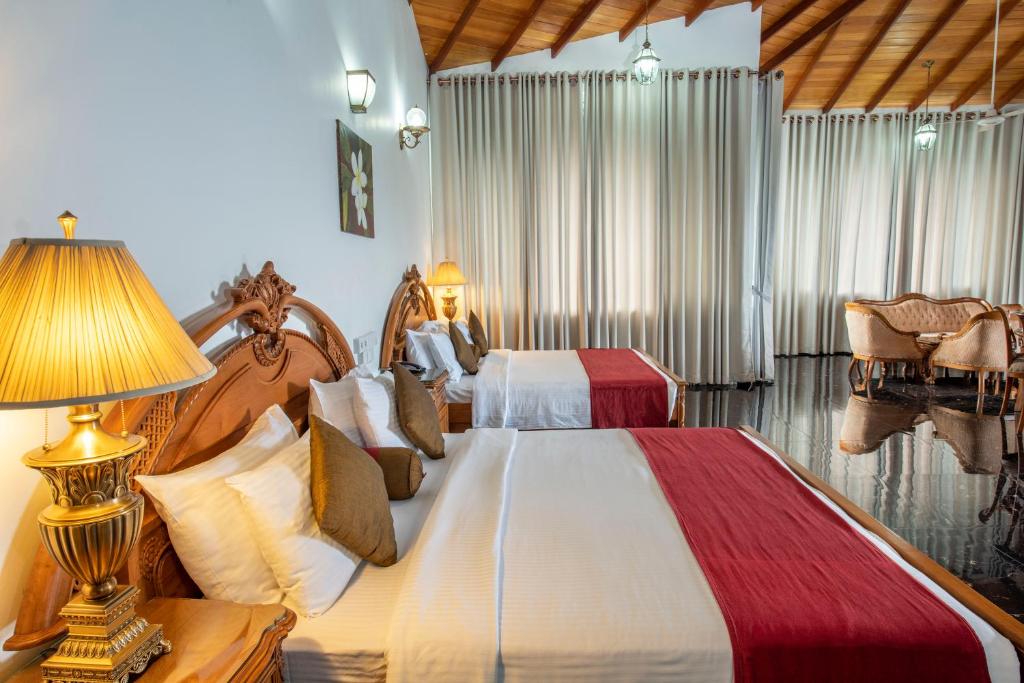 Postel nebo postele na pokoji v ubytování Hotel Sudu Araliya