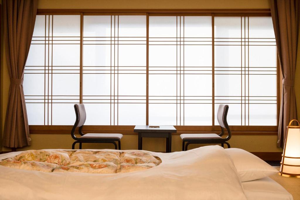 Una cama o camas en una habitación de Ito Kowakien