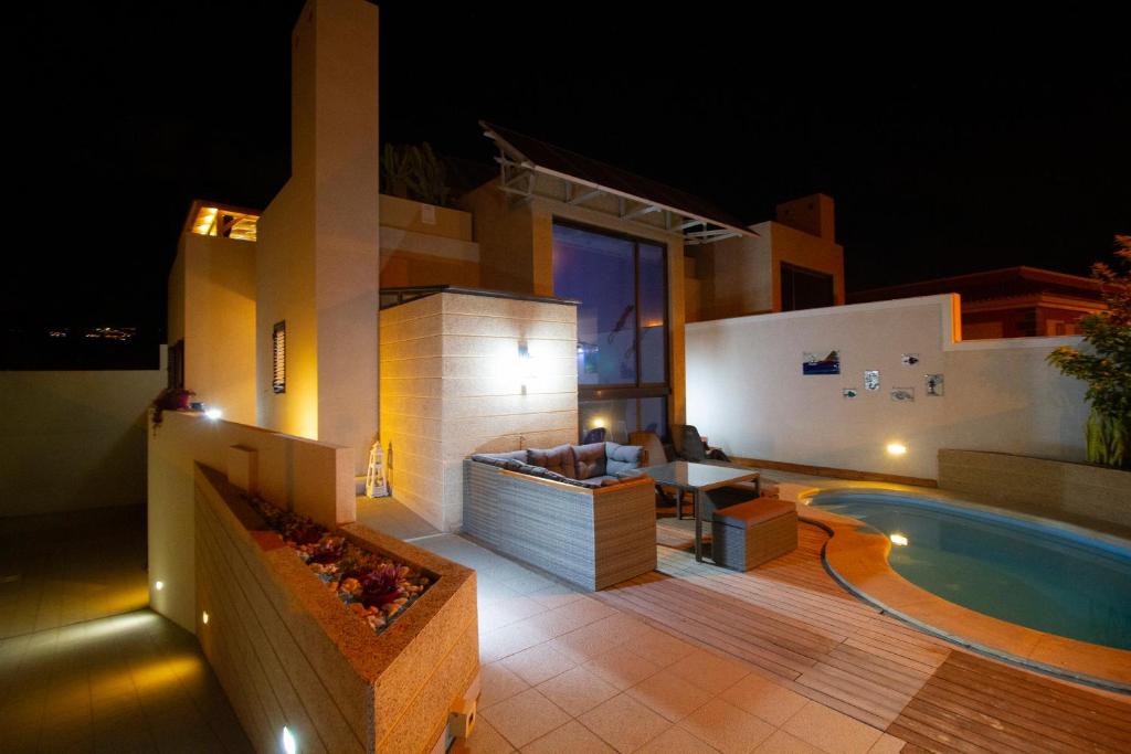 a villa with a swimming pool at night at MEDANO4YOU Casa Violeta in El Médano