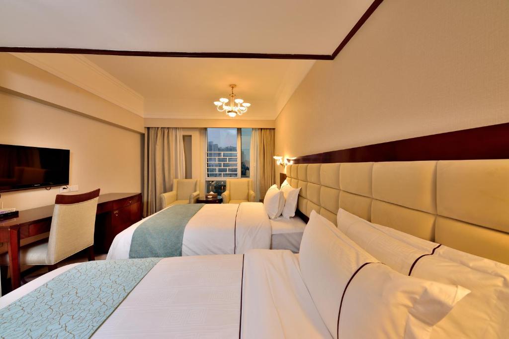 Postel nebo postele na pokoji v ubytování Hai Jun Hotel Guangzhou Beijing Road Tianzi Wharf Store