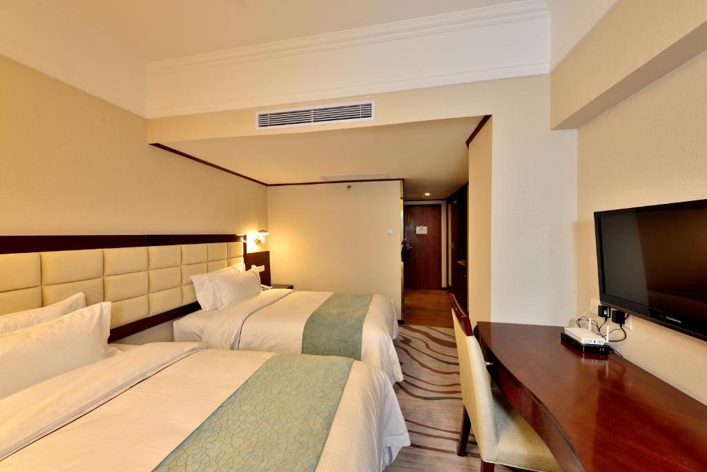 Postel nebo postele na pokoji v ubytování Hai Jun Hotel Guangzhou Beijing Road Tianzi Wharf Store