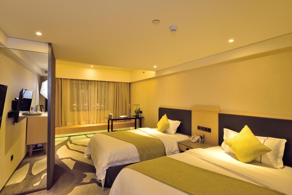 Postel nebo postele na pokoji v ubytování Hai Jun Hotel Guangzhou Beijing Road Tianzi Wharf Store