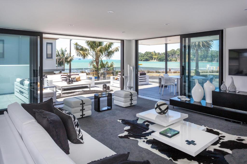 a living room with a white couch and a table at Waters Edge B&B in Whitianga