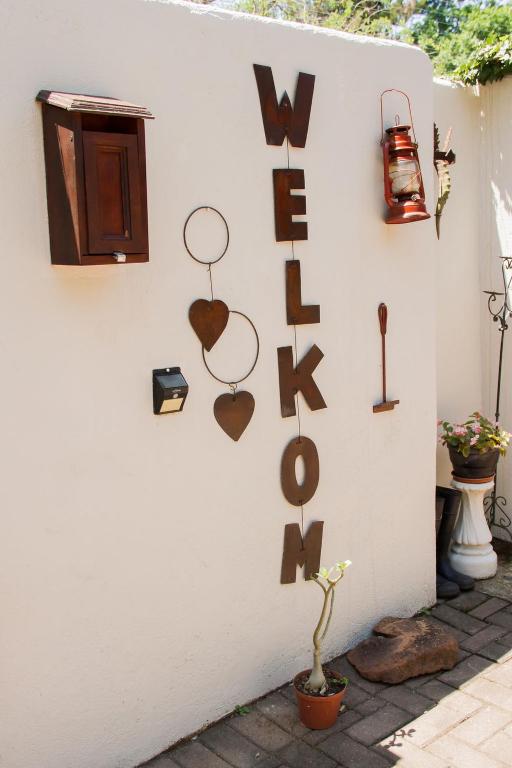 a wall with hearts and letters on it at Rustic Butler B&B in White River