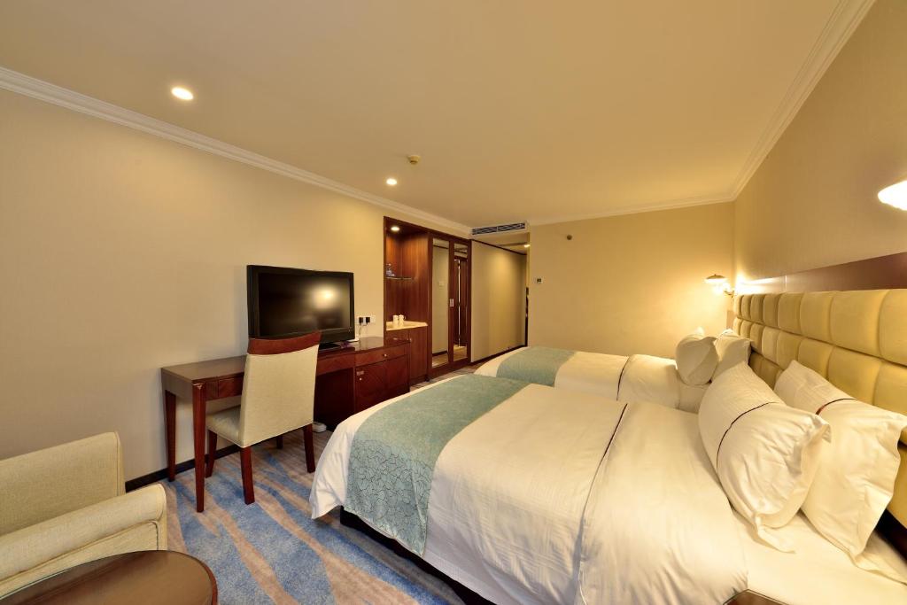 Postel nebo postele na pokoji v ubytování Hai Jun Hotel Guangzhou Beijing Road Tianzi Wharf Store